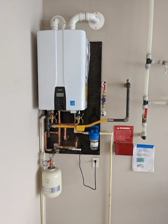 Professional plumber installing copper piping in a Sacaton home